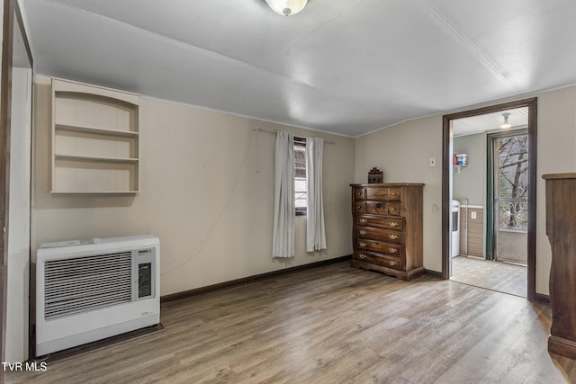 interior space featuring hardwood / wood-style floors and heating unit