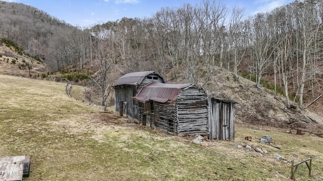 view of outbuilding featuring a mountain view and a yard