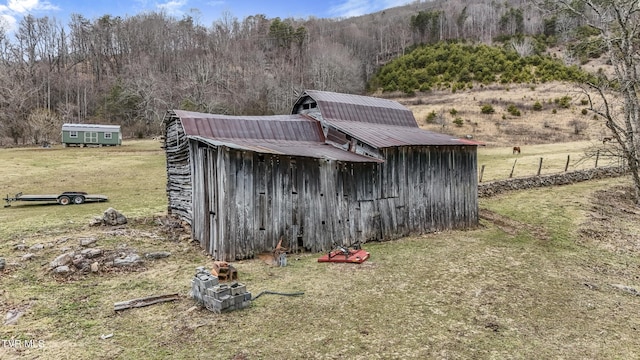 view of outbuilding featuring a lawn