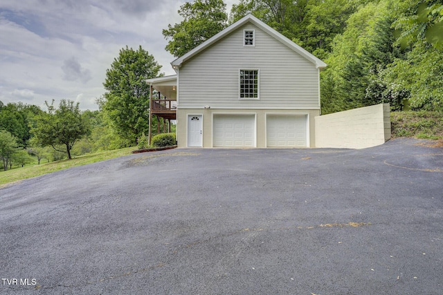 view of home's exterior with an attached garage and driveway