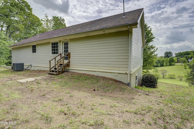 rear view of house featuring entry steps and central AC unit