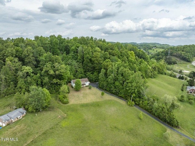 birds eye view of property with a view of trees