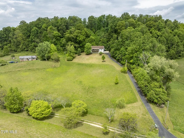 drone / aerial view with a wooded view