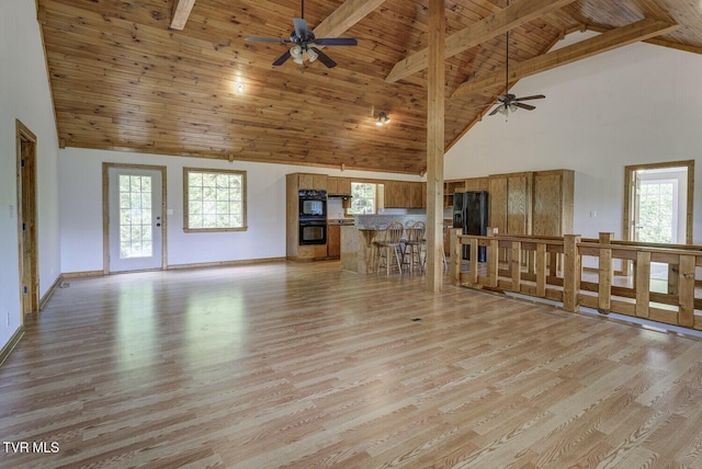 unfurnished living room with wood ceiling, ceiling fan, high vaulted ceiling, beamed ceiling, and light wood finished floors