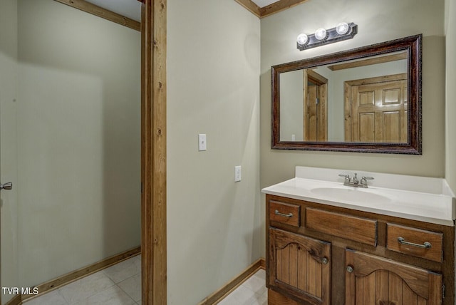 bathroom with baseboards, tile patterned floors, and vanity