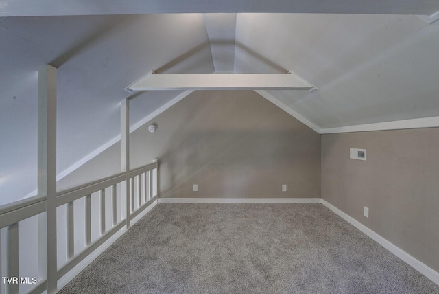 additional living space featuring carpet floors, baseboards, lofted ceiling, and visible vents