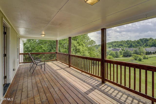 wooden deck featuring a yard