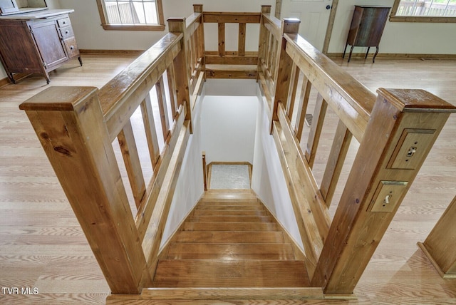 staircase with wood finished floors