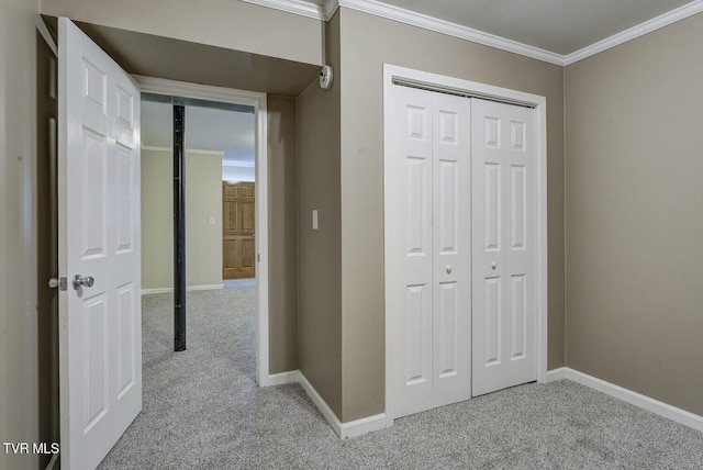 hallway featuring carpet floors, crown molding, and baseboards