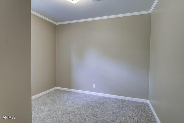 carpeted empty room featuring baseboards and ornamental molding