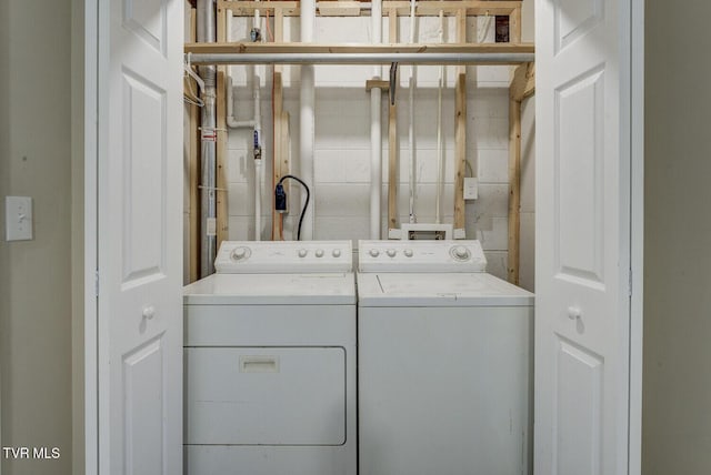 laundry area with washing machine and clothes dryer and laundry area
