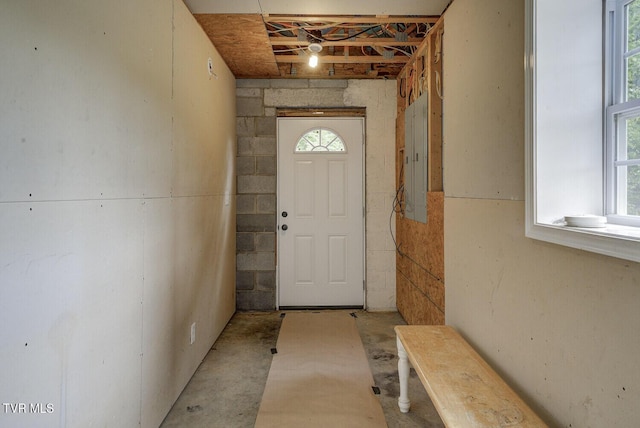 doorway with concrete flooring and electric panel