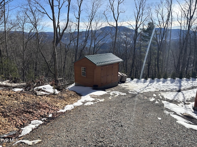 exterior space featuring a mountain view and a storage shed