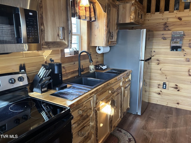 kitchen featuring wooden walls, electric range oven, sink, and dark hardwood / wood-style flooring