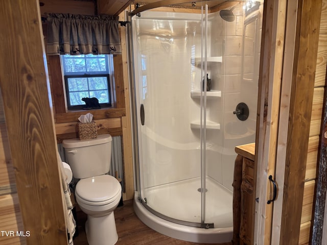 bathroom featuring hardwood / wood-style flooring, vanity, an enclosed shower, and toilet