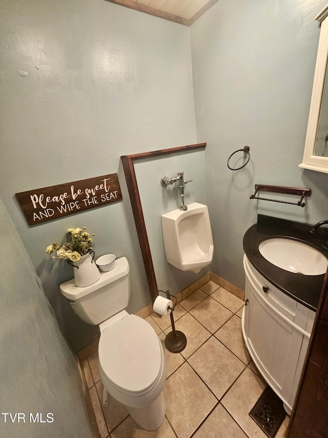 bathroom featuring vanity, tile patterned floors, and toilet