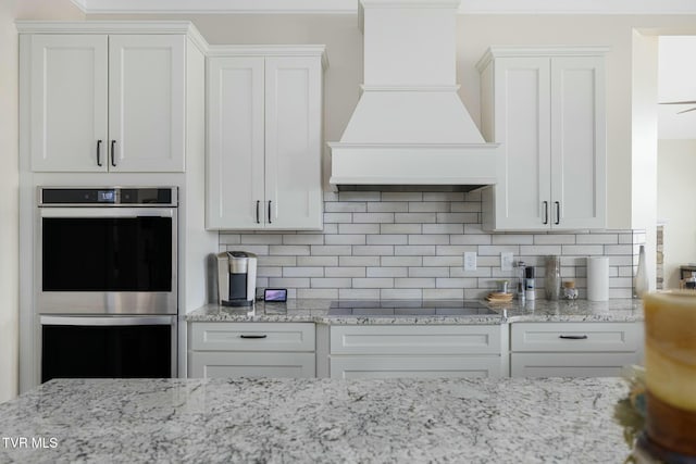 132 Hamilton Rd, Elizabethton, TN 37643 - kitchen featuring premium range hood, stainless steel double oven, black electric cooktop, and white cabinetry