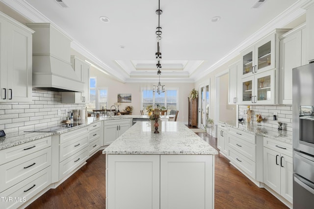 132 Hamilton Rd, Elizabethton, TN 37643 - kitchen featuring black electric cooktop, decorative light fixtures, white cabinetry, and a kitchen island