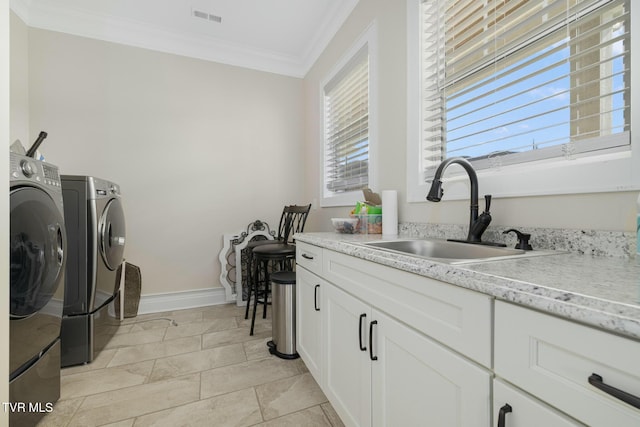 132 Hamilton Rd, Elizabethton, TN 37643 - washroom with sink, ornamental molding, cabinets, and washing machine and clothes dryer