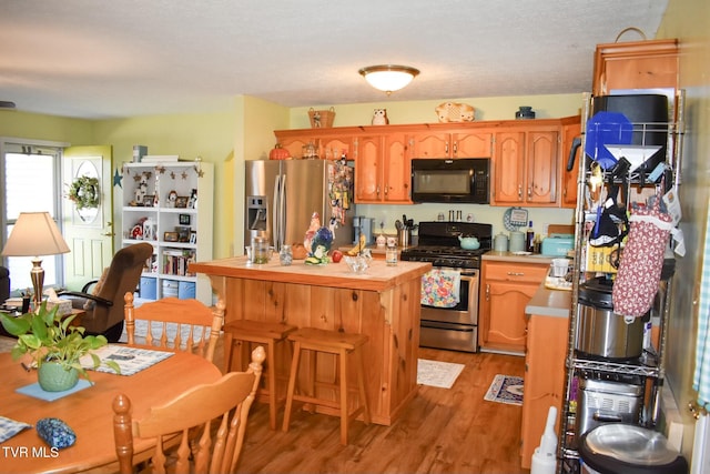 kitchen featuring light hardwood / wood-style flooring and appliances with stainless steel finishes