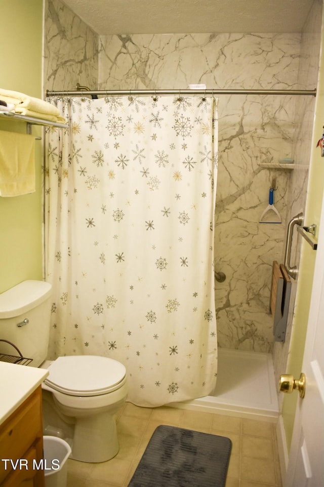 bathroom with vanity, toilet, tile patterned flooring, and a shower with shower curtain