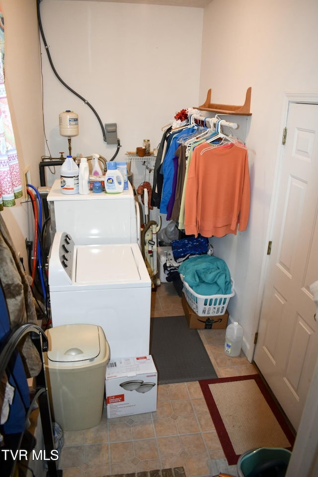 clothes washing area featuring tile patterned flooring and washer / dryer