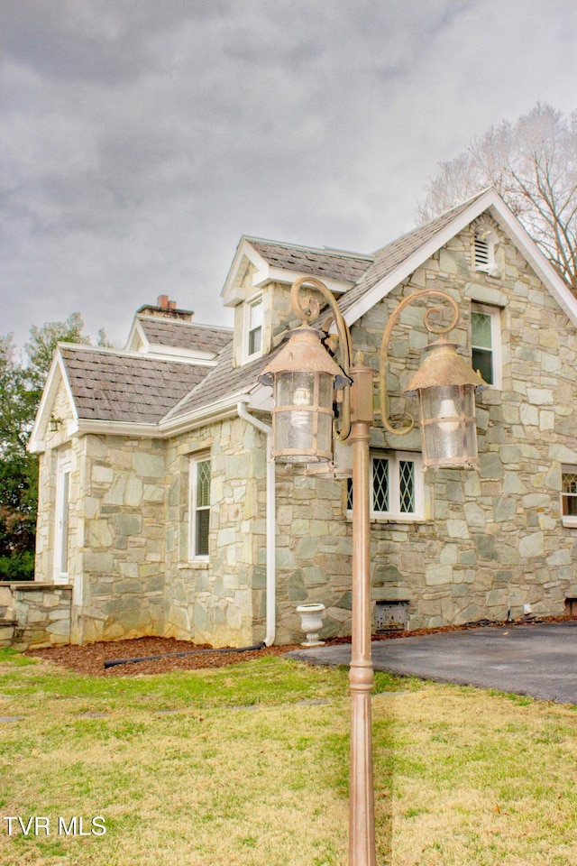 view of side of home featuring a lawn