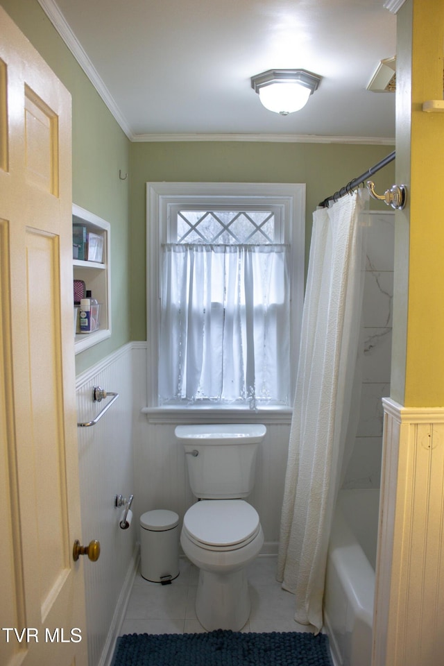 bathroom with tile patterned flooring, ornamental molding, shower / bath combination with curtain, and toilet