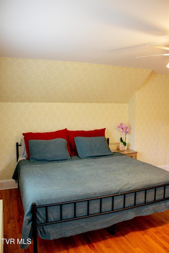 bedroom with hardwood / wood-style floors