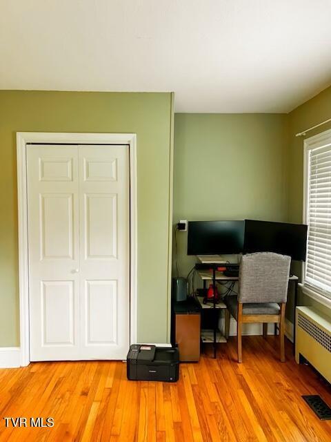 home office with radiator and wood-type flooring