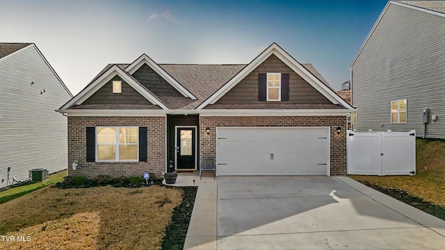 craftsman inspired home with central AC, a garage, and a front yard