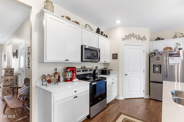 kitchen with white cabinetry, sink, dark hardwood / wood-style floors, and appliances with stainless steel finishes