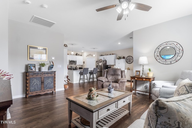 living room with dark wood-type flooring and ceiling fan