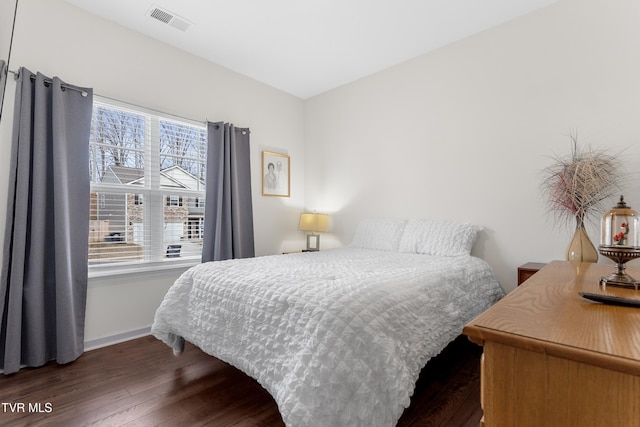 bedroom with dark wood-type flooring