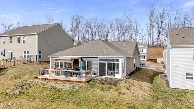 rear view of house with a wooden deck, a yard, and central AC unit