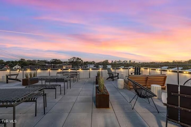 patio terrace at dusk with a water view