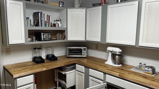 bar with white cabinetry and wooden counters