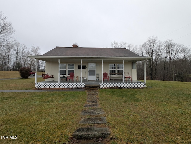 farmhouse inspired home with covered porch and a front lawn