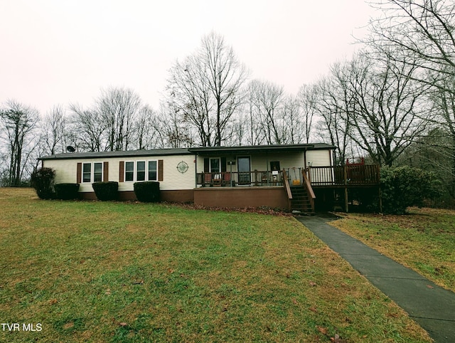 view of front of house featuring a deck and a front lawn