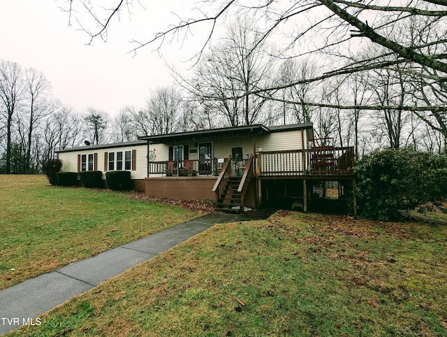 view of front facade featuring a wooden deck and a front yard