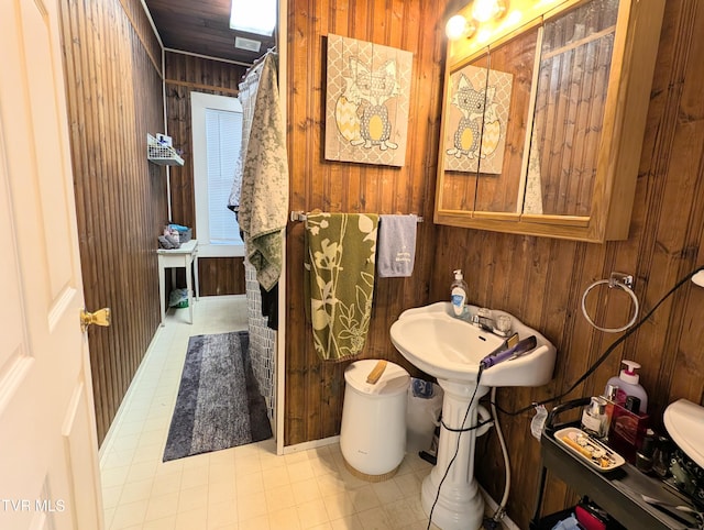 bathroom with wood walls