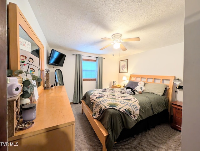 carpeted bedroom with ceiling fan and a textured ceiling