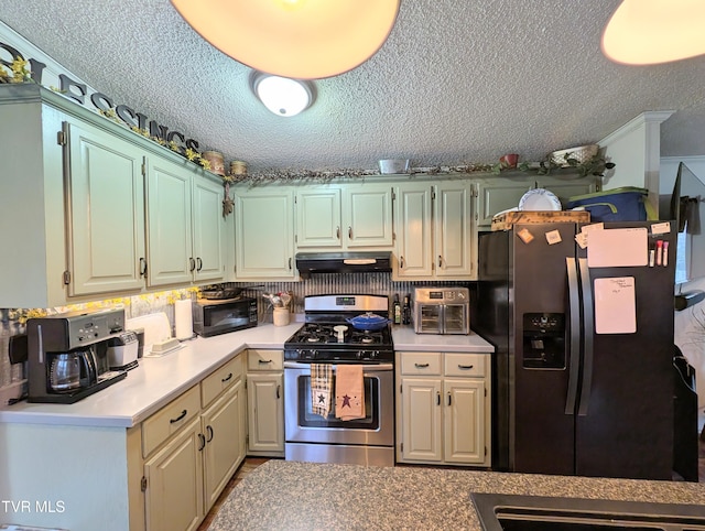 kitchen featuring stainless steel appliances and a textured ceiling