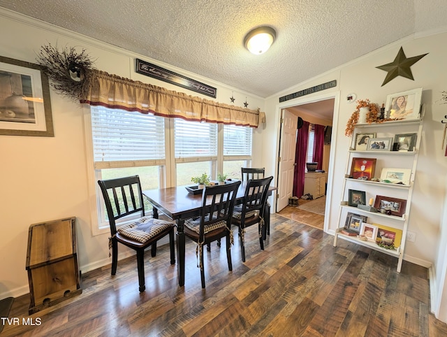 dining space with dark hardwood / wood-style flooring, crown molding, vaulted ceiling, and a textured ceiling