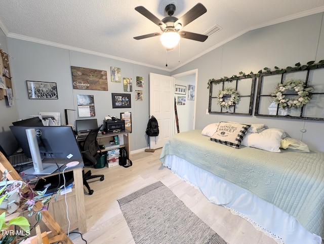 bedroom featuring crown molding, vaulted ceiling, a textured ceiling, ceiling fan, and light hardwood / wood-style floors