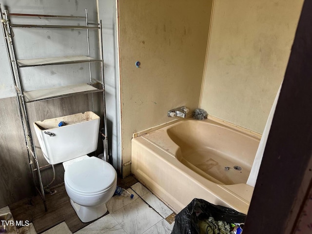 bathroom with toilet and a bathing tub