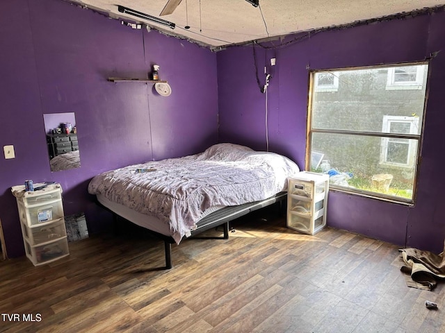 bedroom with dark hardwood / wood-style flooring