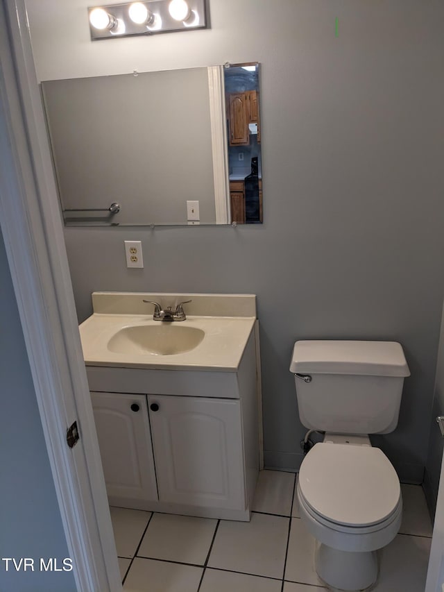 bathroom featuring vanity, tile patterned floors, and toilet