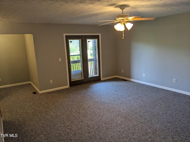 spare room with ceiling fan, a textured ceiling, and dark colored carpet