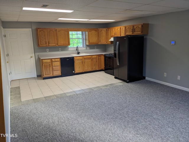 kitchen featuring sink, range hood, a drop ceiling, black appliances, and light carpet